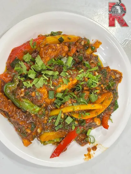 Our plated Chicken Sizzler, a delicious mix of juicy chicken and colourful bell peppers tossed in a thick, spicy sauce and garnished with fresh herbs.