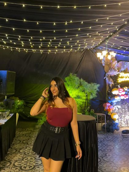 A smiling, candid moment in the party outfit. This captures the fun of a night out with friends.