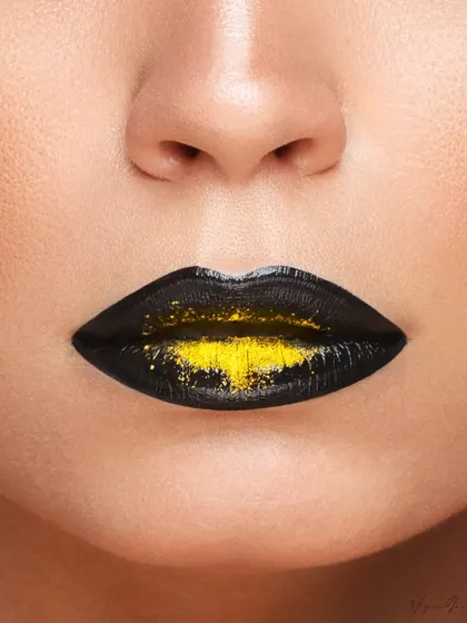 An extreme close-up of the lips, featuring a creative black and yellow glitter effect. This kind of detailed shot is perfect for advertising lip products or showcasing makeup artistry.