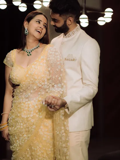 A moment of pure, unscripted laughter. The groom whispers something to his bride-to-be, and her resulting joy is beautifully captured, showcasing the genuine connection that makes for the best photographs.