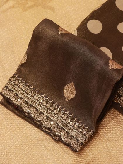 A close-up of the embroidered blouse piece that accompanies the polka dot organza saree.