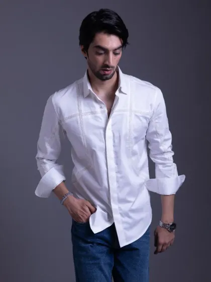 A full view of the white pintuck shirt, paired with jeans for a smart-casual look. The quality of the tailoring makes it a standout piece.