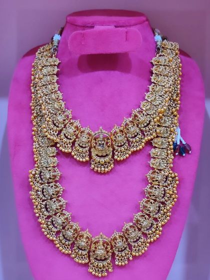 A classic temple jewellery set featuring matching choker and haram with deity motifs.