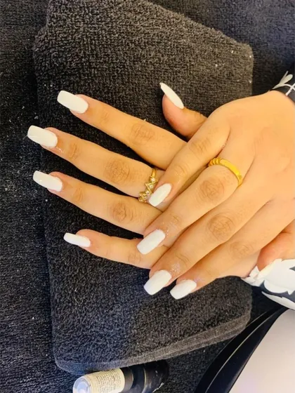 Clean, crisp, and always in style. This manicure features long, square-shaped nails with a solid, opaque white gel polish for a fresh and modern look.