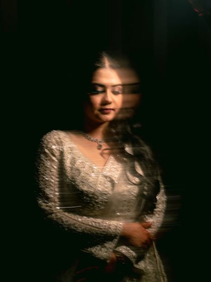 A creative portrait with a vertical blur effect, focusing on the bride's contemplative expression.