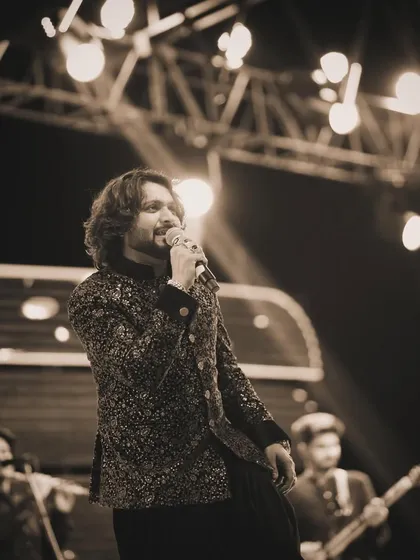 Another sepia-toned shot from a live concert, building anticipation for the next performance.