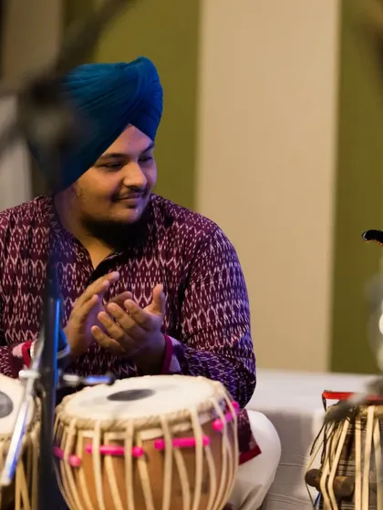 A candid moment of appreciation during the Guruvandan concert. The silent communication between artists on stage is a language of its own.