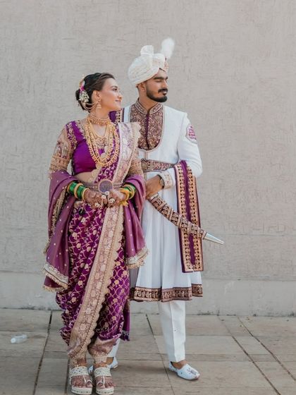 A regal pose showing the elegance of the Peshwai bride and groom. The bride's Nauvari is rich in detail, and her makeup is kept classic to complement the grandeur.