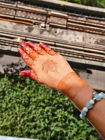 The beautiful, rich stain of a minimalist lotus design, seen against the Mumbai skyline.