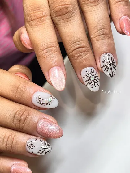 Another look at the sun and moon themed nail art, showing the intricate details and shimmery finish.