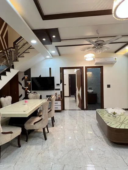 This view shows the complete open-plan living and dining area. The layout is designed for easy flow, making it perfect for family life and entertaining guests.