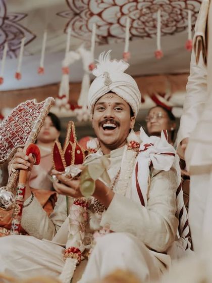 A candid shot of the groom's joyful reaction during a fun moment in the wedding ceremony.