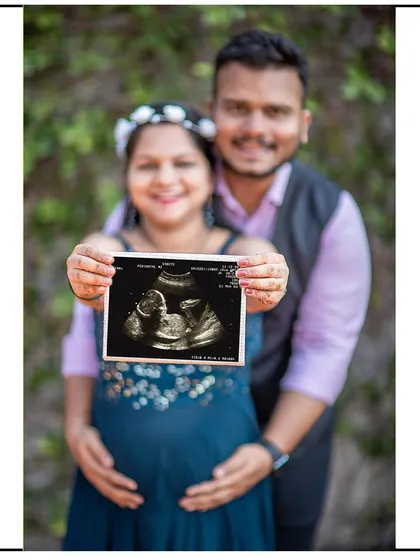 The sonogram takes center stage in this happy couple's portrait, a beautiful way to announce the coming arrival.