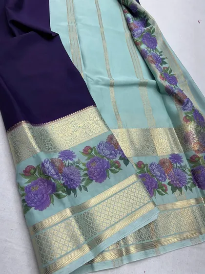 A premium semi-Mysore crepe saree with a Bentex Kalamkari border. This design features a lovely sea green and purple combination with a contrast pallu and blouse.