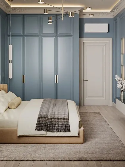 A full view of a bedroom from a 3D render, featuring blue walls with classic molding and a matching floor-to-ceiling wardrobe. The design is elegant and timeless.