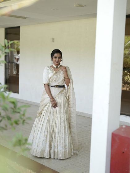 My dear friend Nithya shines in this custom-made light gold lehenga. I designed it with a modern, draped dupatta that can be belted at the waist, creating a look of effortless elegance for her special event.