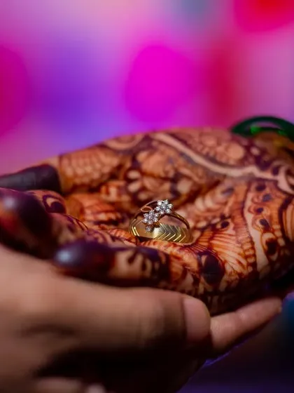 The engagement ring, a symbol of love and commitment, resting in the bride's mehendi-covered palm. A beautiful detail shot from Swapnil and Ankita's ceremony.