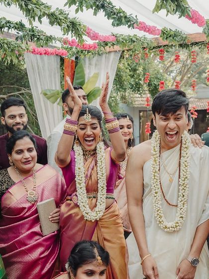 A moment of pure elation from the couple and their family, capturing the high spirits of the wedding day.