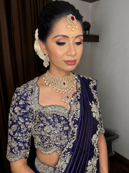 A soft, elegant pose showing the classic hairstyle with fresh flowers.