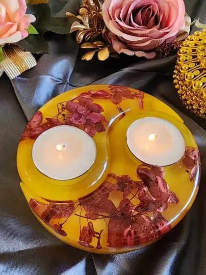 A yellow and red floral tealight holder, perfect for adding a pop of color to your Diwali decor.