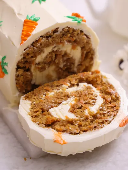 Our Carrot Roll Cake is a delicious Easter treat, filled with cream cheese frosting and decorated with tiny piped carrots.