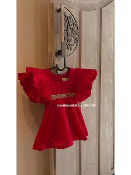 For the little trendsetter in your life, we created this vibrant red velvet party dress. It features dramatic ruffled sleeves and a delicate, hand-embellished waistband, making it a perfect outfit for birthdays, weddings, and special celebrations.