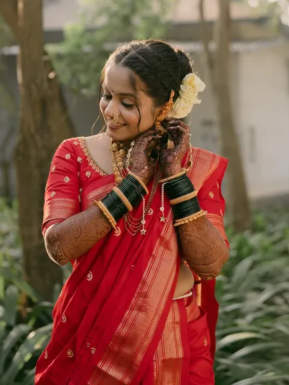 Another shot of the bride adjusting her earring, her smile radiant.