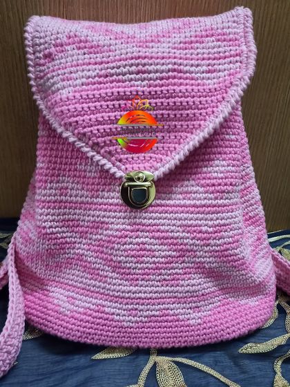 My softy strawberry crush tapestry backpack. The variegated pink yarn creates a lovely marbled effect, and it's finished with a simple fold-over flap and a metal clasp.