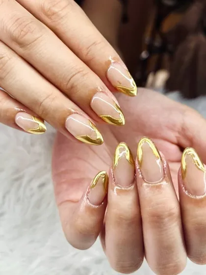 This is my take on the classic French manicure, elevated with liquid gold chrome. I use builder gel for strength and durability, then hand-paint these molten gold accents for a finish that whispers pure luxury.