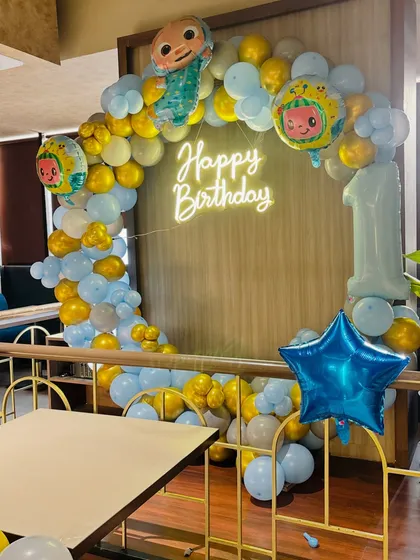 Another perspective of the Cocomelon party decor, showing the number '1' foil balloon.