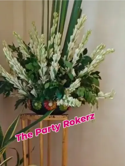 A simple and elegant floral arrangement of white tuberoses (rajnigandha) used as part of the decor for a Teej celebration.