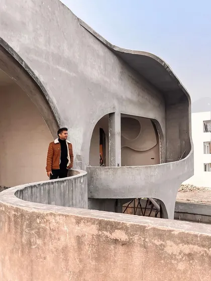 Vijay on site at "La La Land," standing on one of the curved balconies, overseeing the creation of our vision.