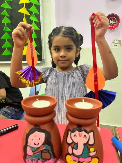 A closer look at the cute, hand-painted tea-light holders and paper hangings made for Diwali.