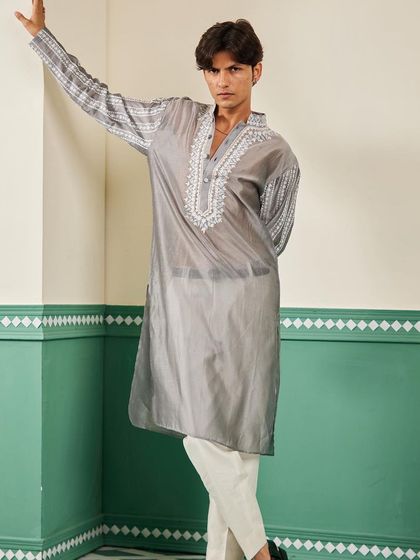 This full-length pose highlights the modern silhouette and the beautiful sheen of the Chanderi silk on our grey kurta.