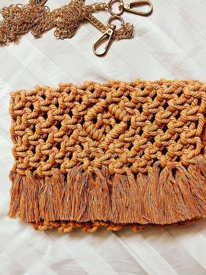 A simple, flat-lay of one of my fringed clutches with its gold chain strap. The texture of the knots is what makes it so special.