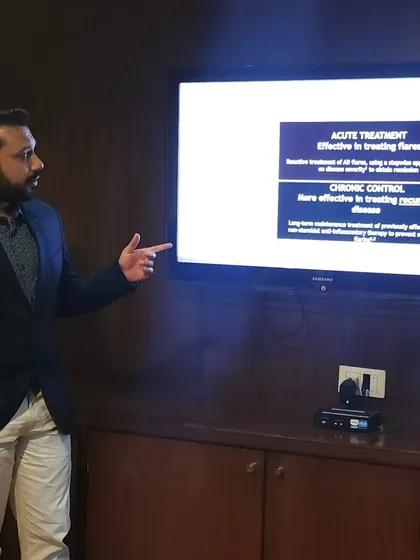 During a presentation, I am explaining the difference between acute treatment for eczema flares and chronic control to prevent them. This highlights my strategic approach to managing long-term skin conditions.