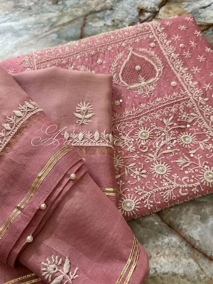 A close-up of the dupatta and sleeve, showing the coordinated embroidery and embellishments.