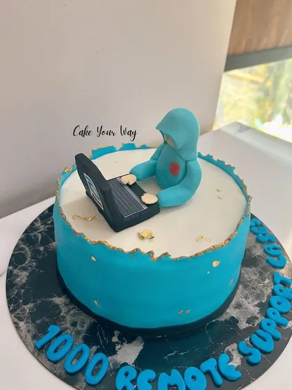 A special cake for a techie, celebrating 1000 remote supports with a fondant figure and laptop.