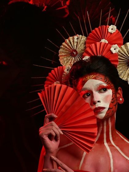 A full-body Geisha-inspired look. The red body paint and intricate headpiece showcase the level of detail and creativity involved in our fantasy makeup projects.