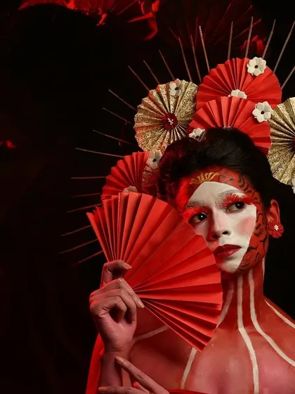 A full-body Geisha-inspired look. The red body paint and intricate headpiece showcase the level of detail and creativity involved in our fantasy makeup projects.