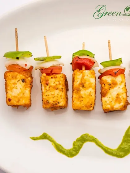 A vegetarian classic, our Paneer Tikka is marinated in flavorful spices and grilled to perfection. We serve it on skewers with chunks of onion and bell peppers, accompanied by a fresh mint chutney.