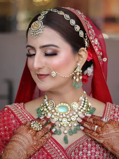 Another close-up with eyes closed, highlighting the flawless eye makeup and how it complements the tones in her jewelry.