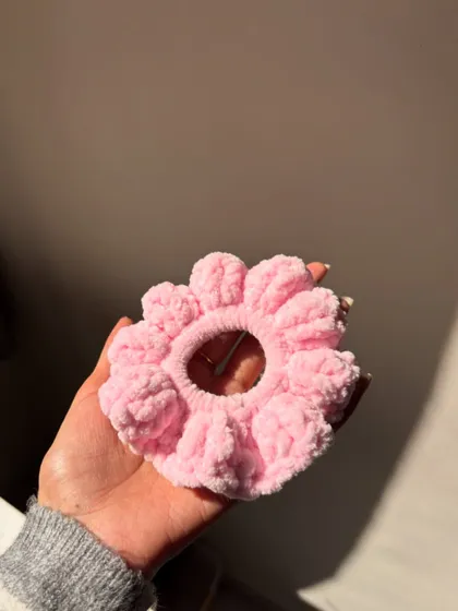 This petal-like crochet scrunchie is made with super soft pink velvet yarn. It's gentle on your hair and looks just like a flower when you wear it.