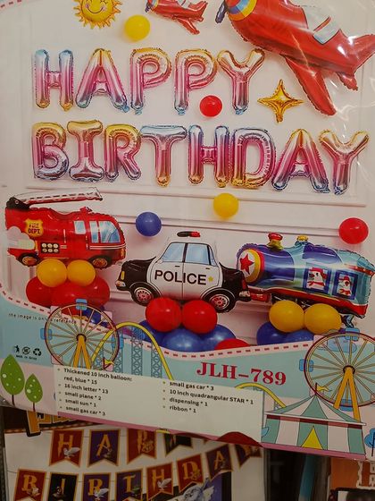 For the little vehicle enthusiast, this transportation-themed birthday kit is perfect. It features foil balloons shaped like a police car, fire truck, and train, along with a 'Happy Birthday' banner.