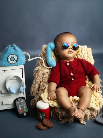 The Baby Boss is on an important call. The tiny sunglasses and confident pose make this shot absolutely priceless.