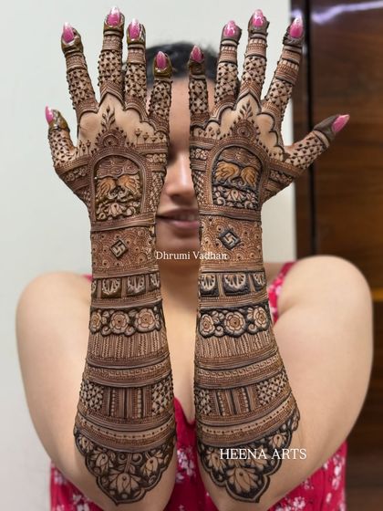 A close-up of a detailed bridal back-hand design. I've incorporated graceful swan motifs and auspicious swastika symbols within the intricate patterns.