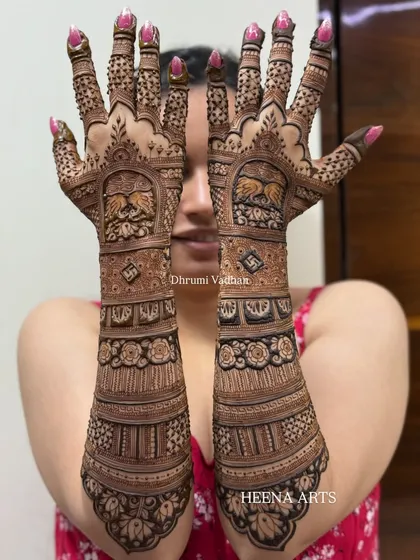 A close-up of a detailed bridal back-hand design. I've incorporated graceful swan motifs and auspicious swastika symbols within the intricate patterns.