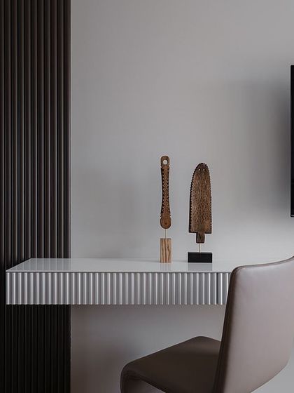 Fluted panels and louvers are the new trend. This image shows a close-up of a sleek TV unit design that uses vertical fluted panels to add texture and elegance in a minimal way.