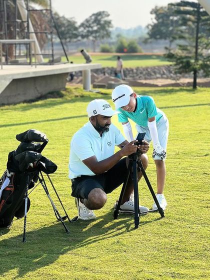 Empowering young players with knowledge is key. Here, a coach shows a junior golfer his swing on a phone, helping him visualize the changes we are working on.