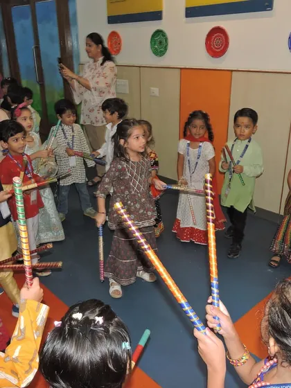 Students enjoy a group Dandiya dance, learning coordination and rhythm while celebrating one of India's most joyous festivals.